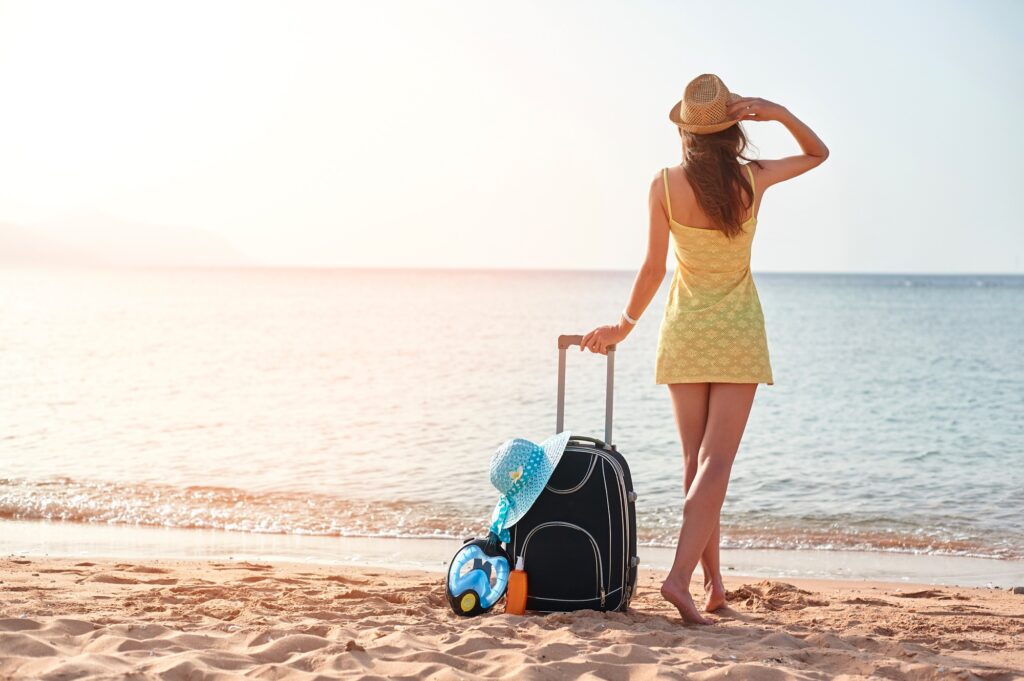 Traveller with a suitcase by the sea Traveller with a suitcase by the sea