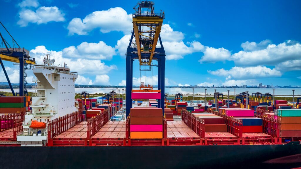 Quay cranes loading containers at a busy container terminal