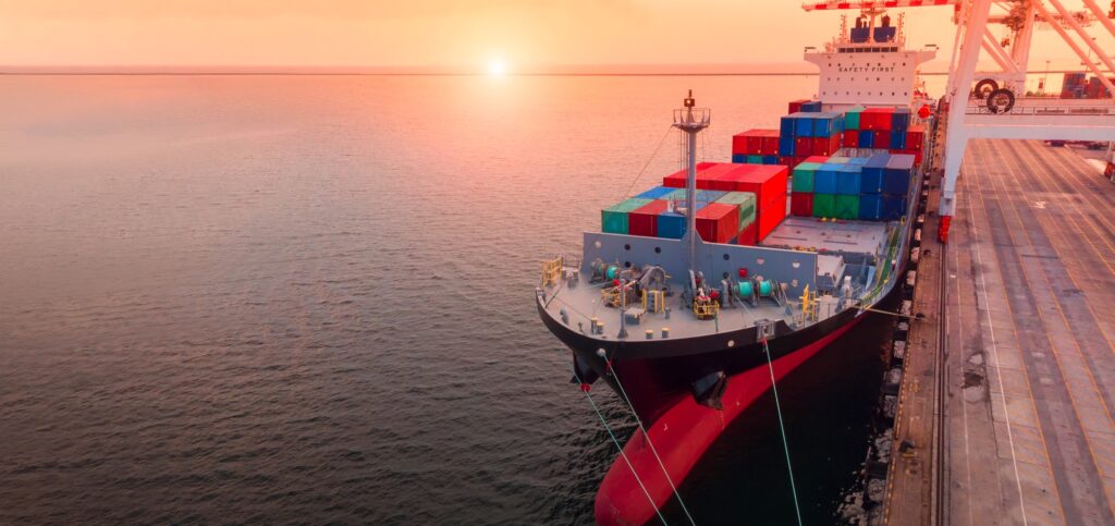 Crane loading a container onto a ship Crane loading a container onto a ship