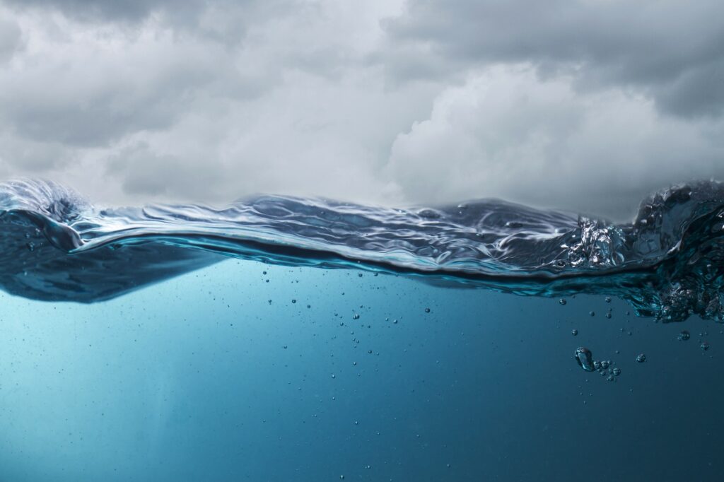 Deep blue sea in stormy weather seen from below the waves