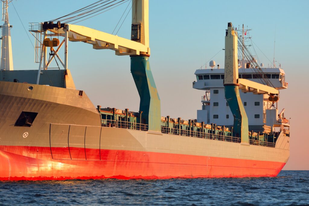 Large cargo ship sailing at sunset